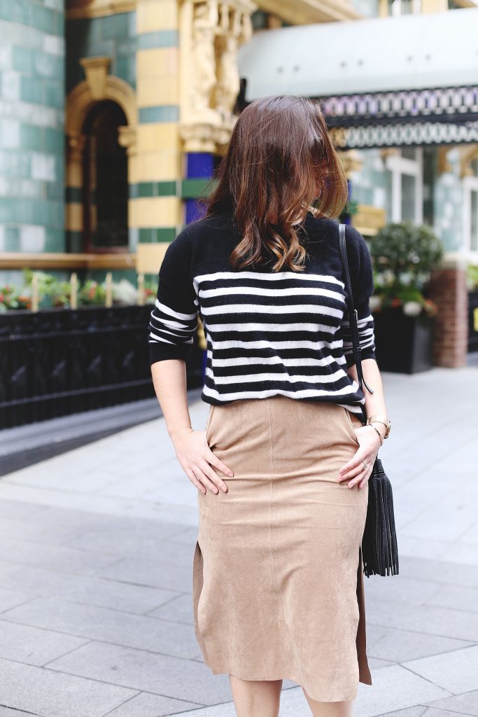 Tan suede skirt, black striped cashmere sweater.