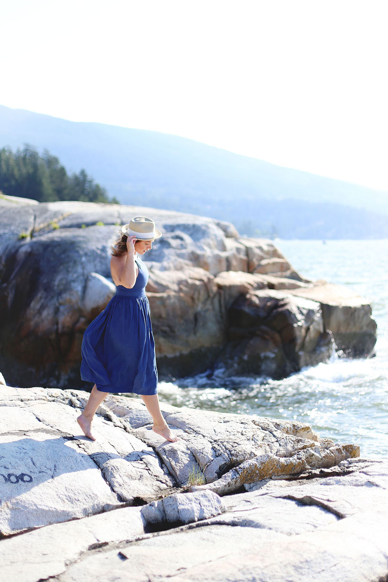 To Vogue or Bust wearing Wilfred by Aritzia dress and straw hat at Lighthouse Park, Vancouver, Canada