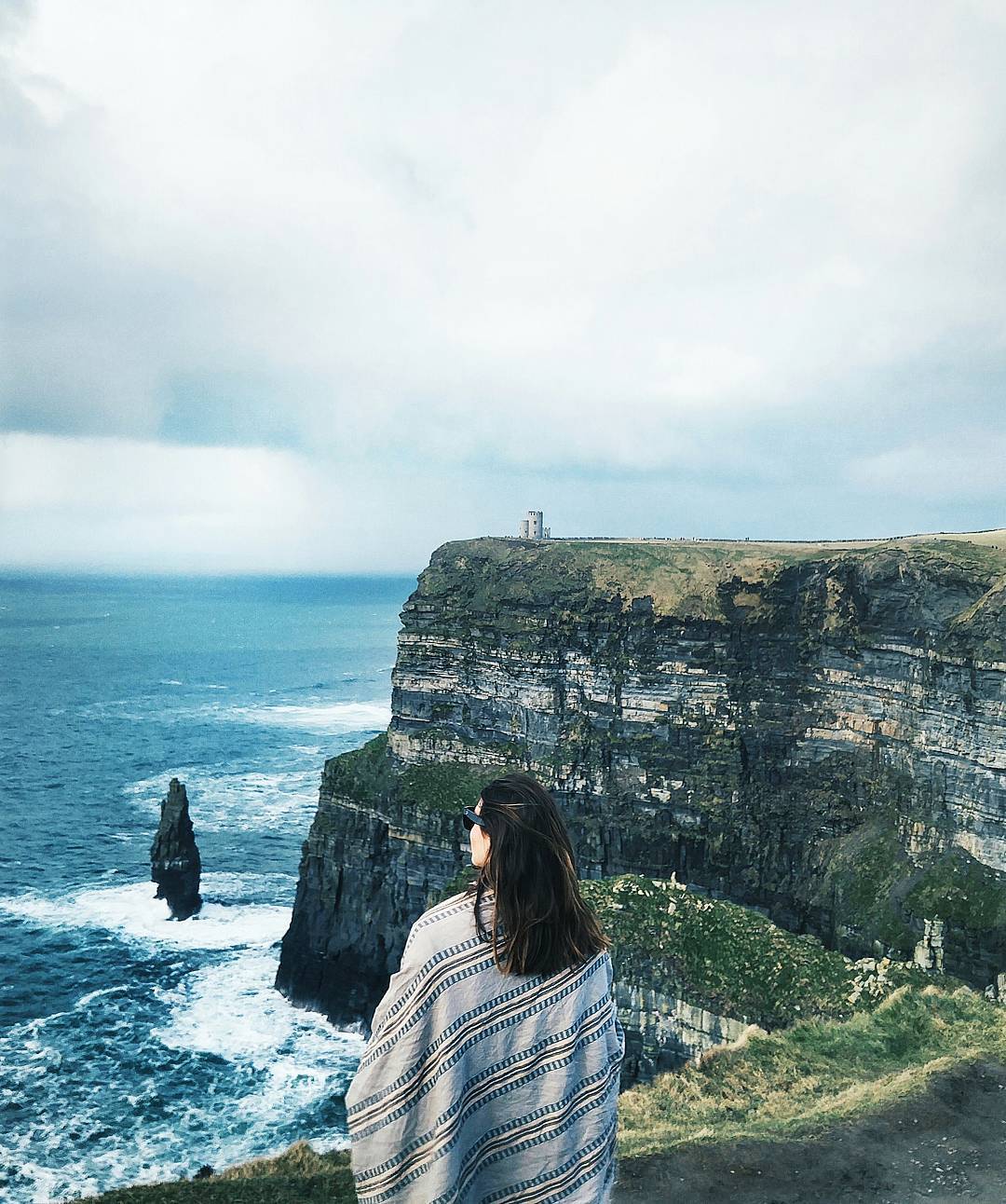 To Vogue or Bust in an Aritzia wrap scarf at the Cliffs of Moher, County Clare, Ireland