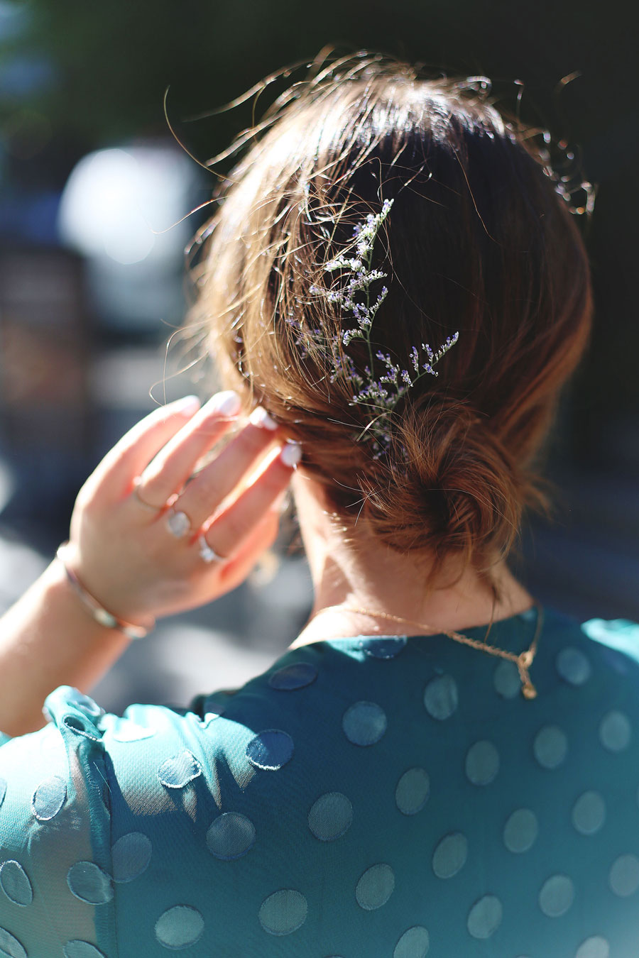 To Vogue or Bust shares what to wear to a black tie wedding in a green dotted Revole Tularosa dress, Ted Baker pink clutch, Leah Alexandra rings and Swarovski rings, and a low chignon.