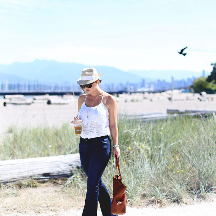 To Vogue or Bust in Mavi flare jeans, Urban Outfitters crochet top, Madewell leather bag, Aritzia straw hat at Jericho Beach in Vancouver
