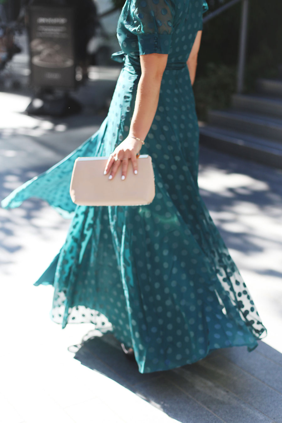 To Vogue or Bust shares what to wear to a black tie wedding in a green dotted Revole Tularosa dress, Ted Baker pink clutch and a low chignon.