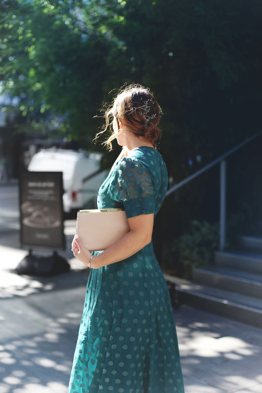 To Vogue or Bust shares what to wear to a black tie wedding in a TULAROSA by Revolve green maxi dress and Ted Baker clutch