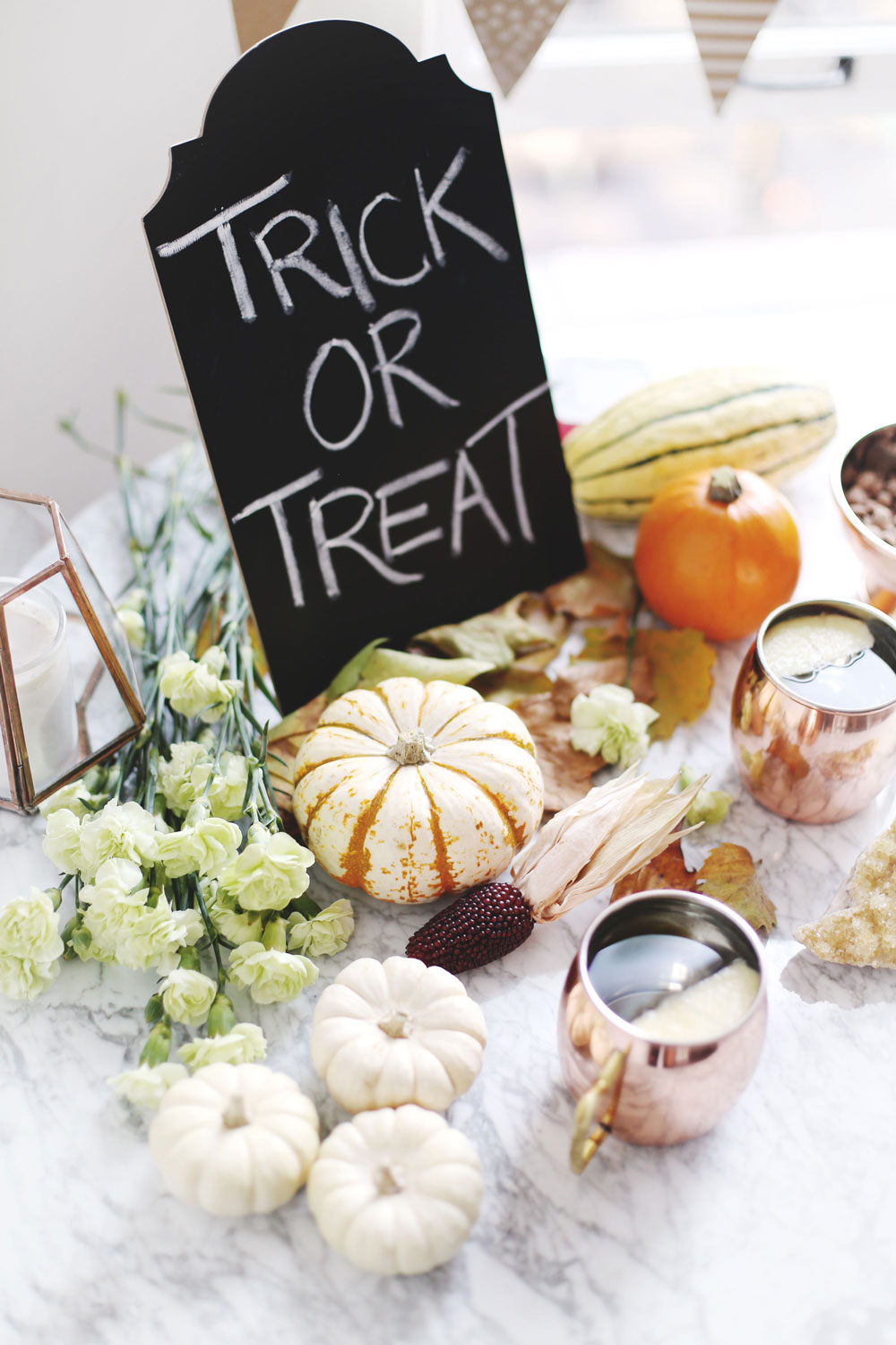 Halloween party hosting tips with Etsy products including copper cups, paper decorations and pumpkin styling