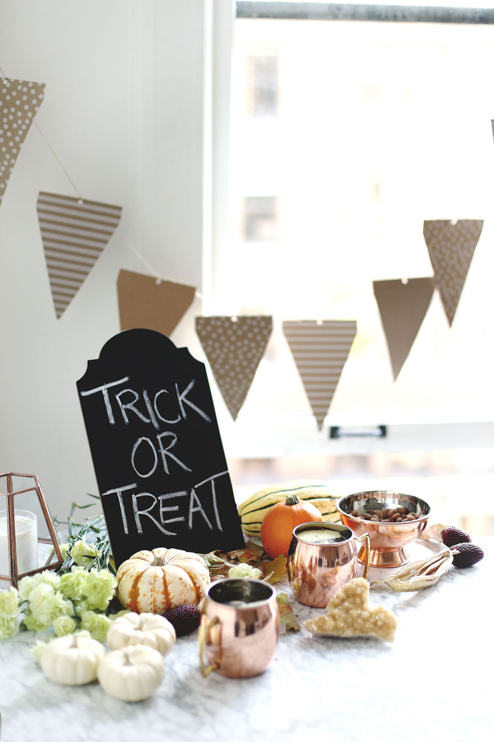 Halloween party hosting tips with Etsy products including copper cups, paper decorations and pumpkin styling