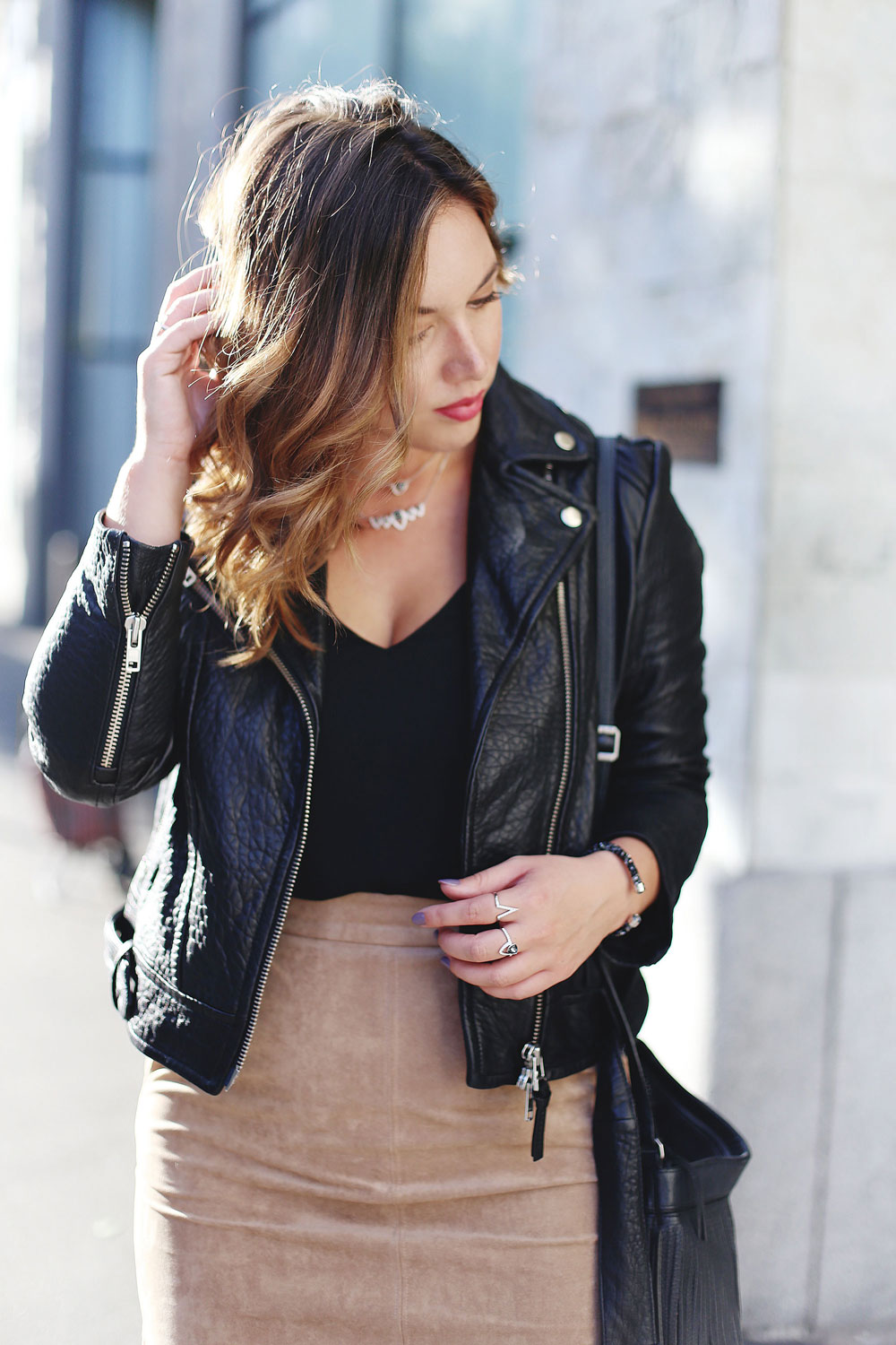 How to layer jewelry in Swarovski jewelry, Aritzia suede pencil skirt, Aritzia black camisole, Mackage leather jacket, Express black heels and Aritzia Wilfred fringe leather bag