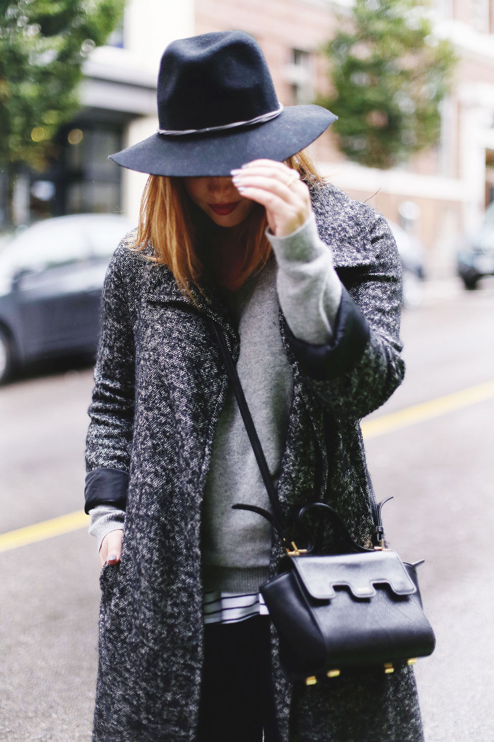 Rainy day outfit ideas for fall, featuring Aritzia Babaton wool trench coat, White and Warren cashmere sweater, striped tank top, Express black wool fedora, Mezzi Mini Cosma bag, Hunter rain boots