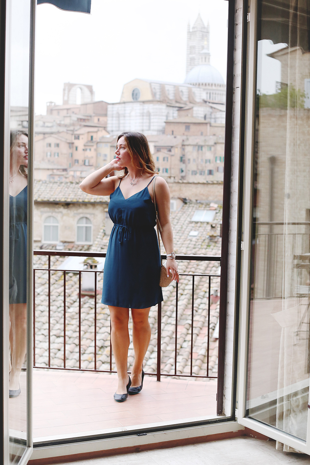 To Vogue or Bust shares jewelry stacking tips in Swarovski jewelry, Aritzia silk dress, Tieks flats and vintage Bottega Venata bag in Siena, Italy