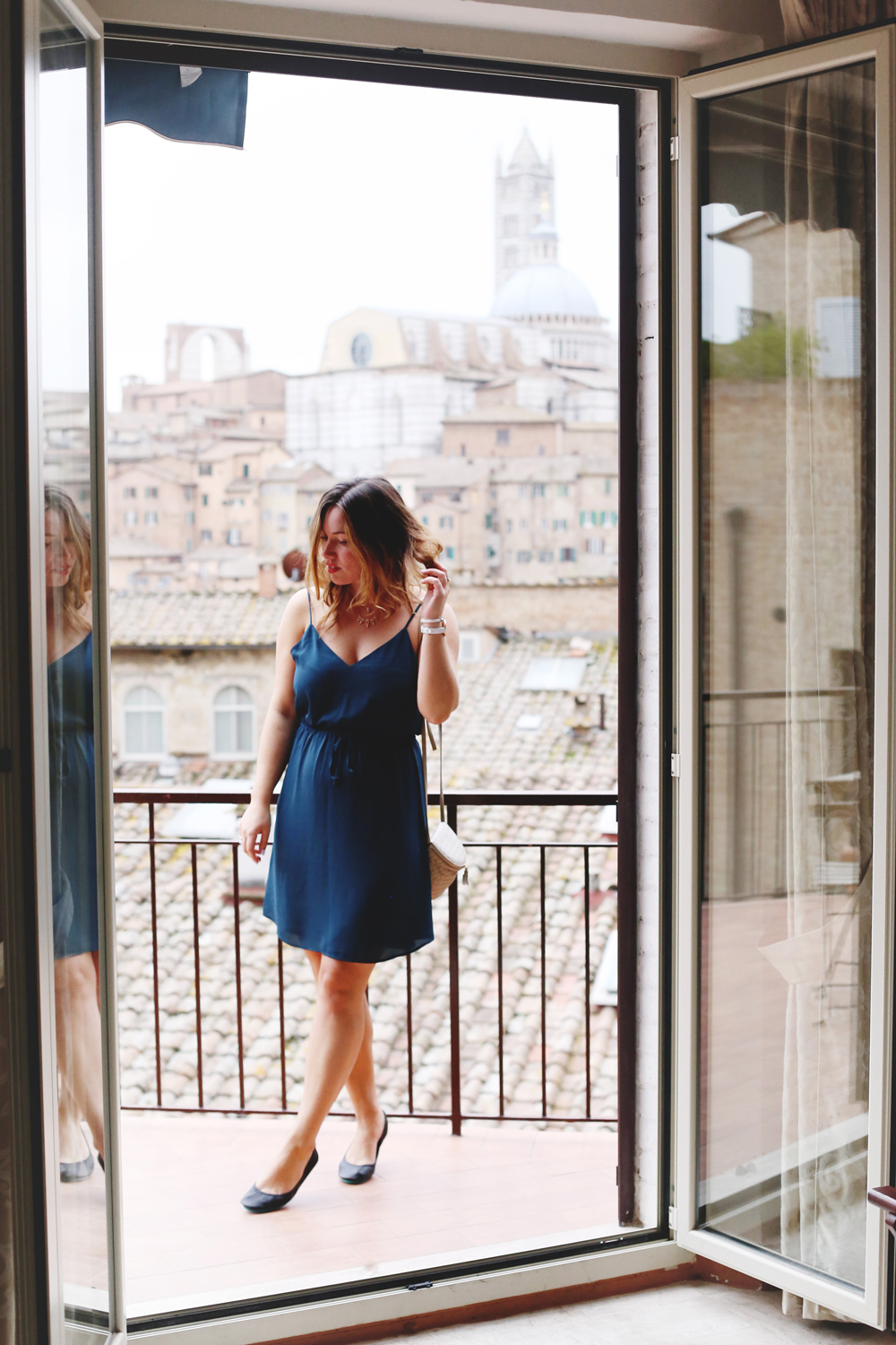 To Vogue or Bust shares jewelry stacking tips in Swarovski jewelry, Aritzia silk dress, Tieks flats and vintage Bottega Venata bag in Siena, Italy