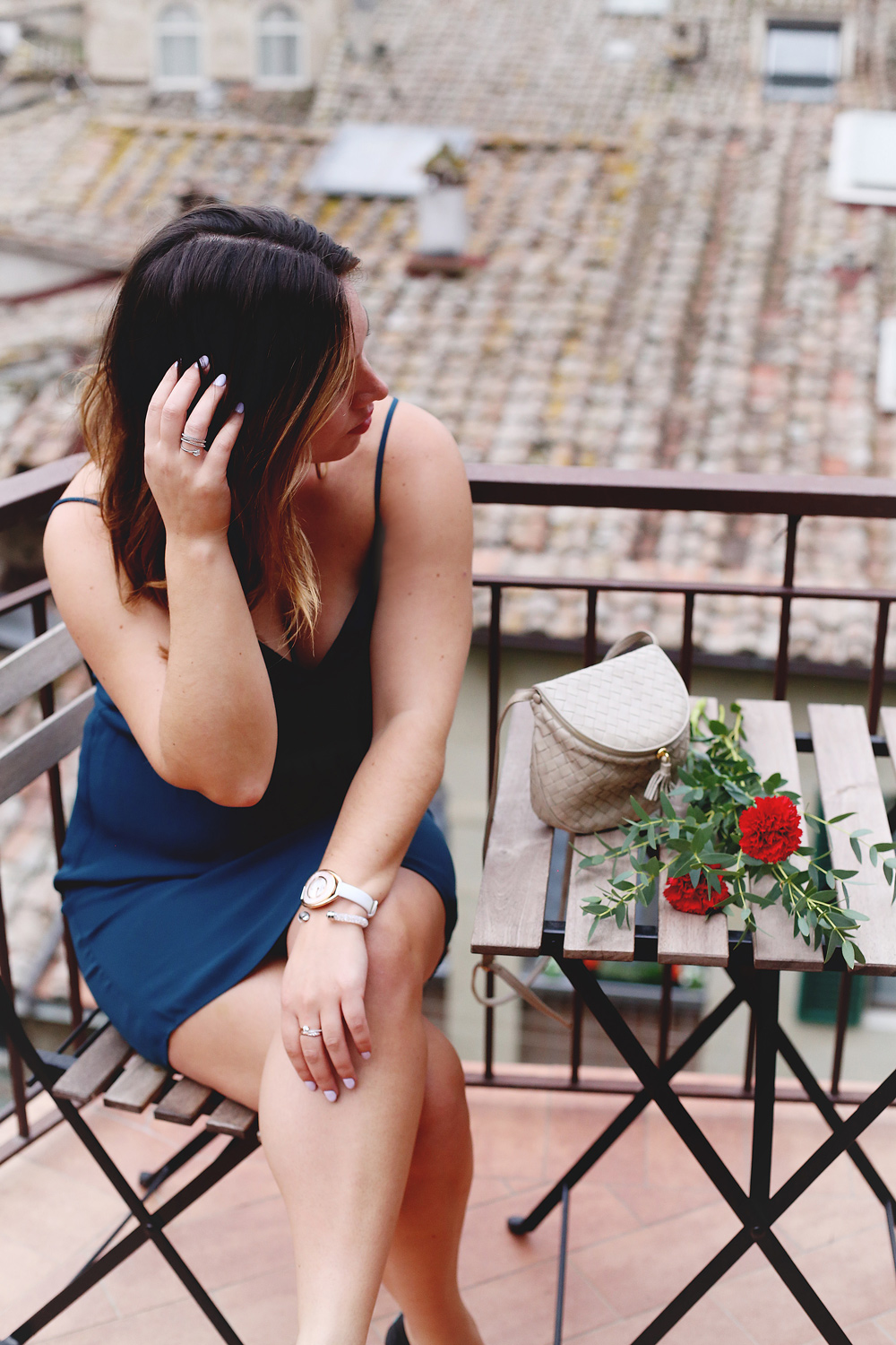 To Vogue or Bust shares jewelry stacking tips in Swarovski jewelry, Aritzia silk dress, Tieks flats and vintage Bottega Venata bag in Siena, Italy