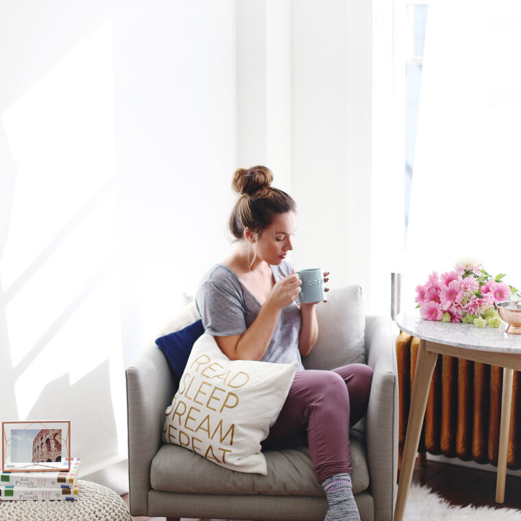 To Vogue or Bust shares how to start a book club in an airy minimalist studio space featuring Chapters books, Chapters decor, Chapters pillows