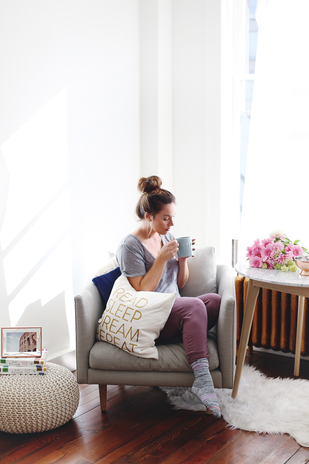 To Vogue or Bust shares how to start a book club in an airy minimalist studio space featuring Chapters books, Chapters decor, Chapters pillows