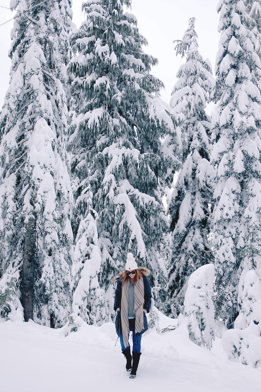 Best winter outfit ideas in the snow in Aritzia Community parka, James jeans skinny jeans, White and Warren cashmere sweater, Aritzia blanket scarf, Hershel beanie, Sorel snow boots styled by To Vogue or Bust at Grouse Mountain, Vancouver