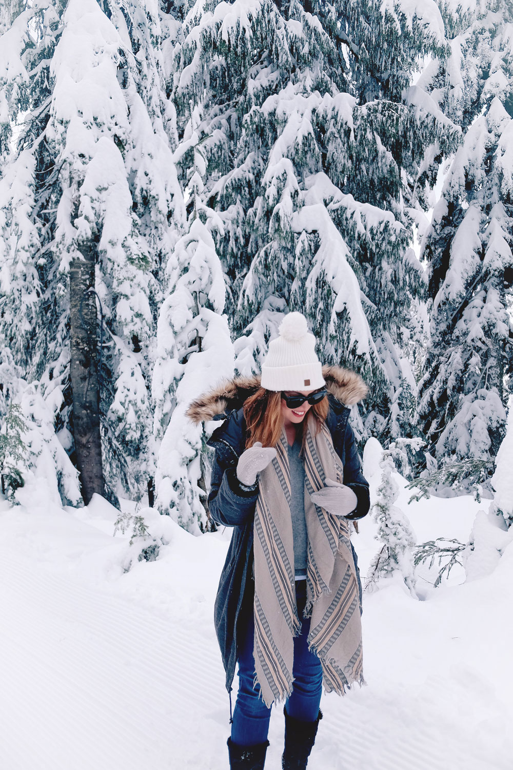 Best winter outfit ideas in the snow in Aritzia Community parka, James jeans skinny jeans, White and Warren cashmere sweater, Aritzia blanket scarf, Hershel beanie, Sorel snow boots styled by To Vogue or Bust at Grouse Mountain, Vancouver