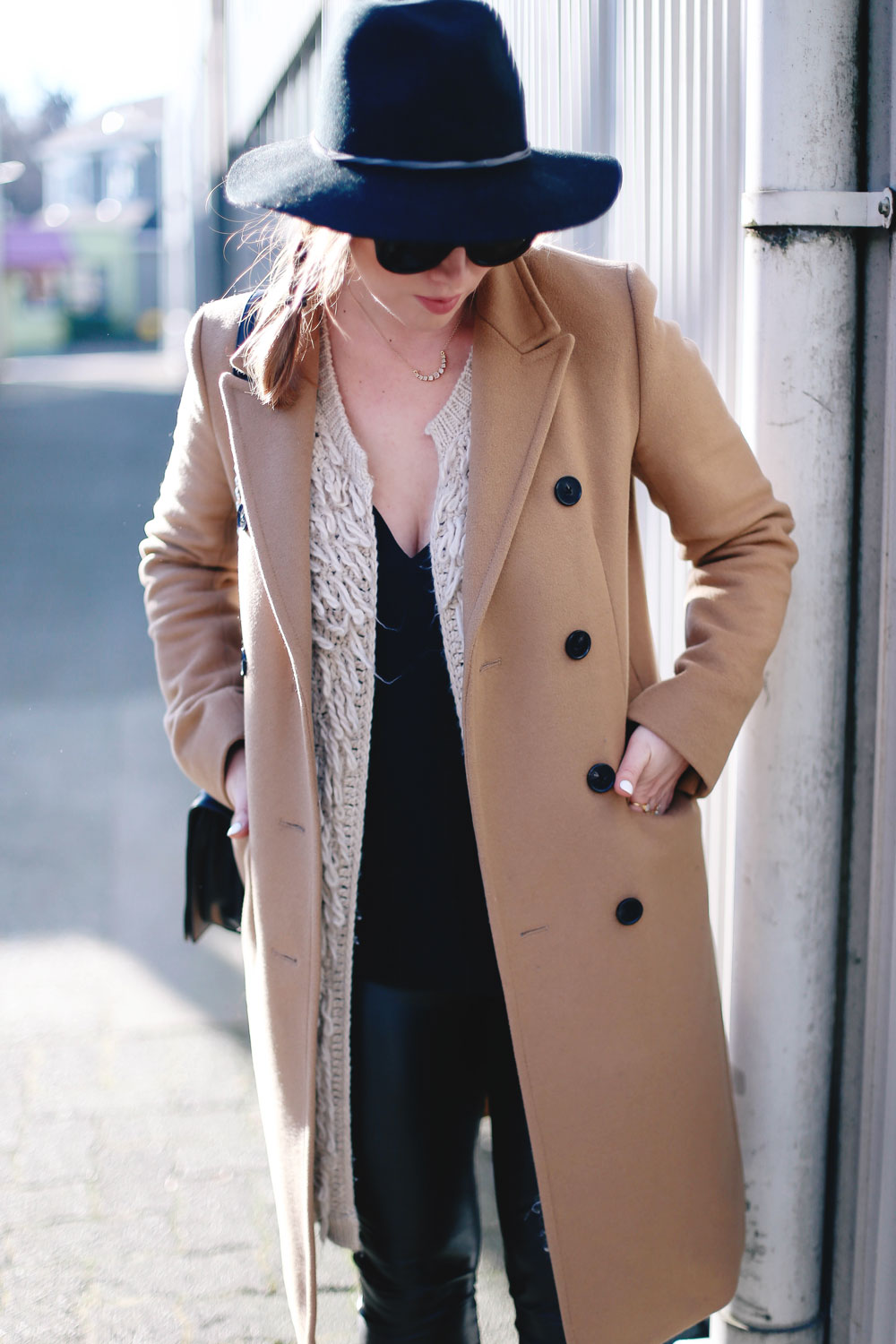 Best winter to spring transition piece in a camel wool coat, leather leggings, leopard cross body bag, statement vest and wool fedora