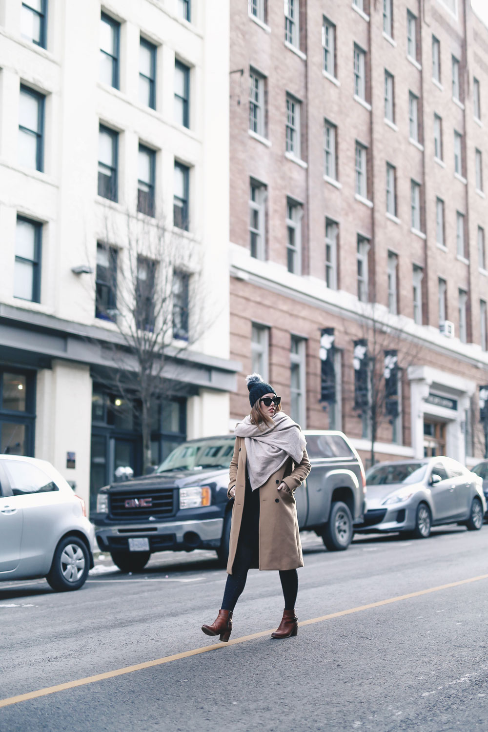 Tips on wearing a dress in the winter styled by To Vogue or Bust in an Aritzia camel wool coat, White and Warren cashmere dress, White and Warren cashmere travel wrap, Frye ankle boots, Express beanie hat and Celine Caty sunglasses