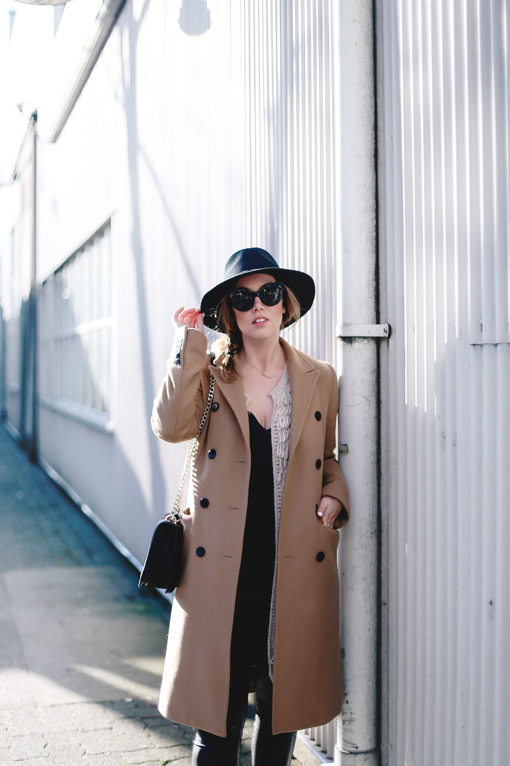 Best winter to spring transition piece in a camel wool coat, leather leggings, leopard cross body bag, statement vest and wool fedora