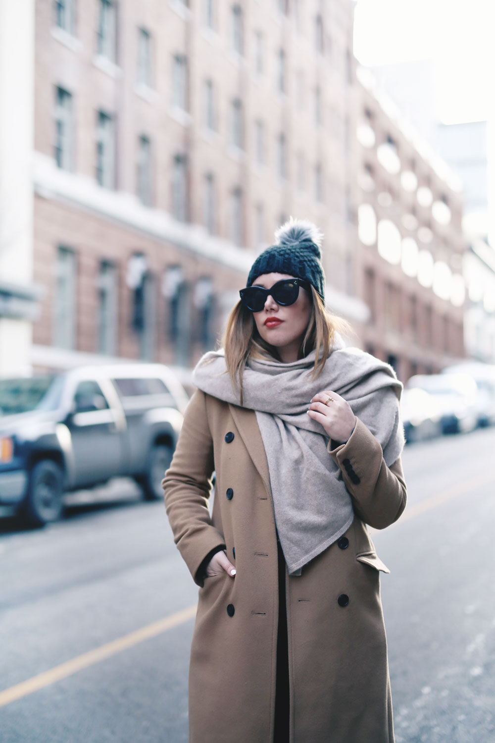 Tips on wearing a dress in the winter styled by To Vogue or Bust in an Aritzia camel wool coat, White and Warren cashmere dress, White and Warren cashmere travel wrap, Frye ankle boots, Express beanie hat and Celine Caty sunglasses