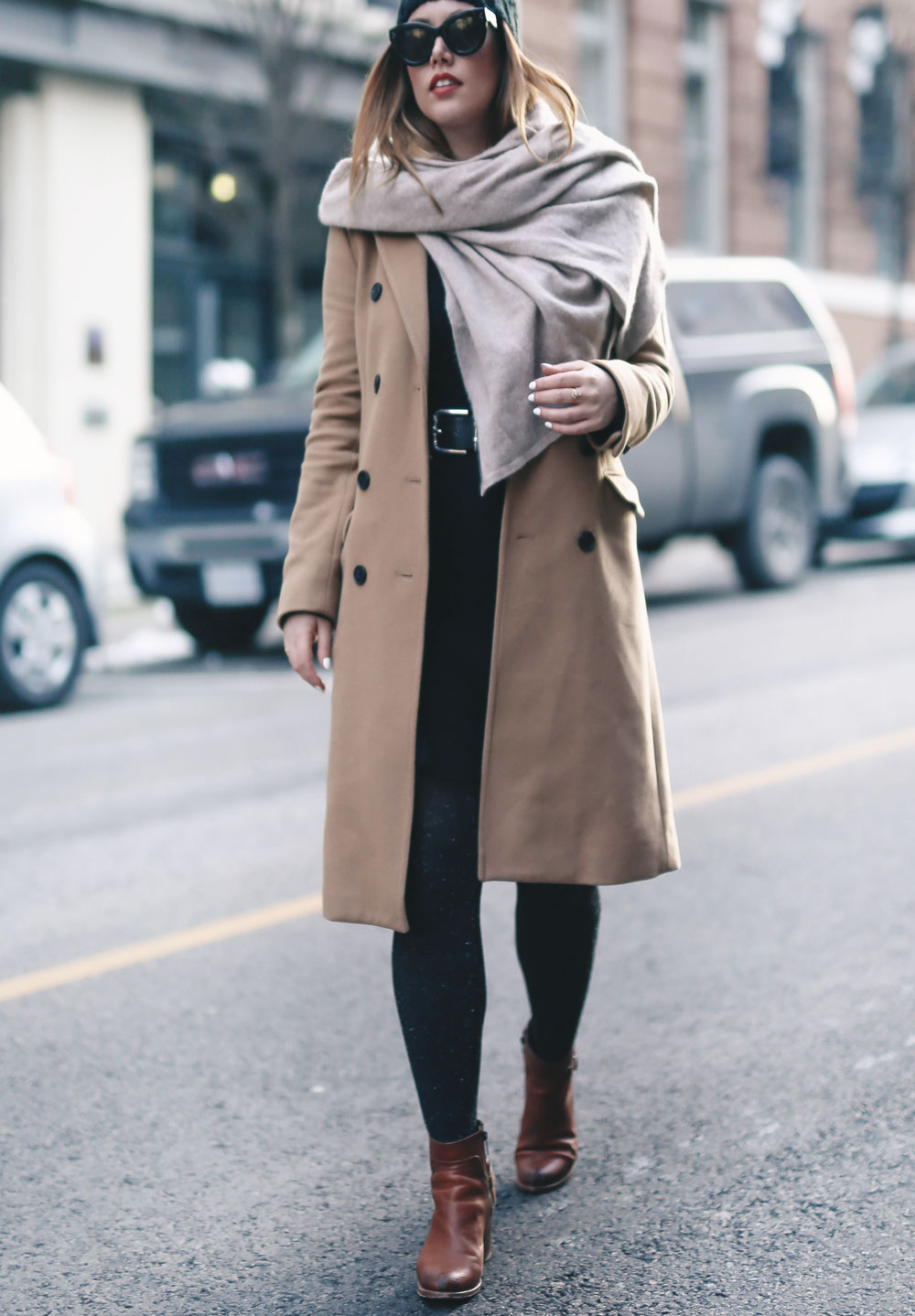 Tips on wearing a dress in the winter styled by To Vogue or Bust in an Aritzia camel wool coat, White and Warren cashmere dress, White and Warren cashmere travel wrap, Frye ankle boots, Express beanie hat and Celine Caty sunglasses