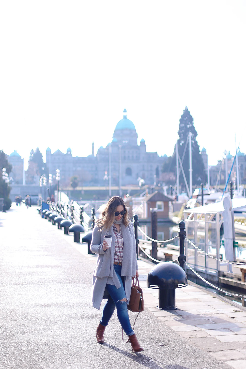 Plaid shirt styling tips in a grey wool coat, grey cashmere scarf, ripped skinny jeans, leather ankle boots and red plaid shirt