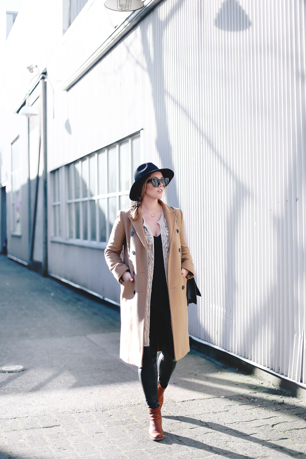 Best winter to spring transition piece in a camel wool coat, leather leggings, leopard cross body bag, statement vest and wool fedora