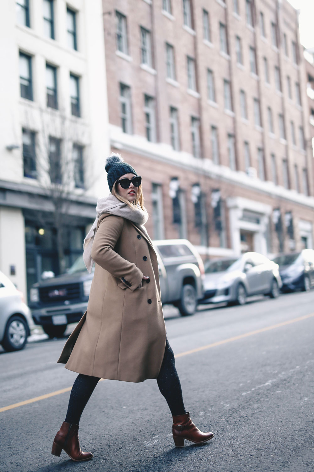 Tips on wearing a dress in the winter styled by To Vogue or Bust in an Aritzia camel wool coat, White and Warren cashmere dress, White and Warren cashmere travel wrap, Frye ankle boots, Express beanie hat and Celine Caty sunglasses