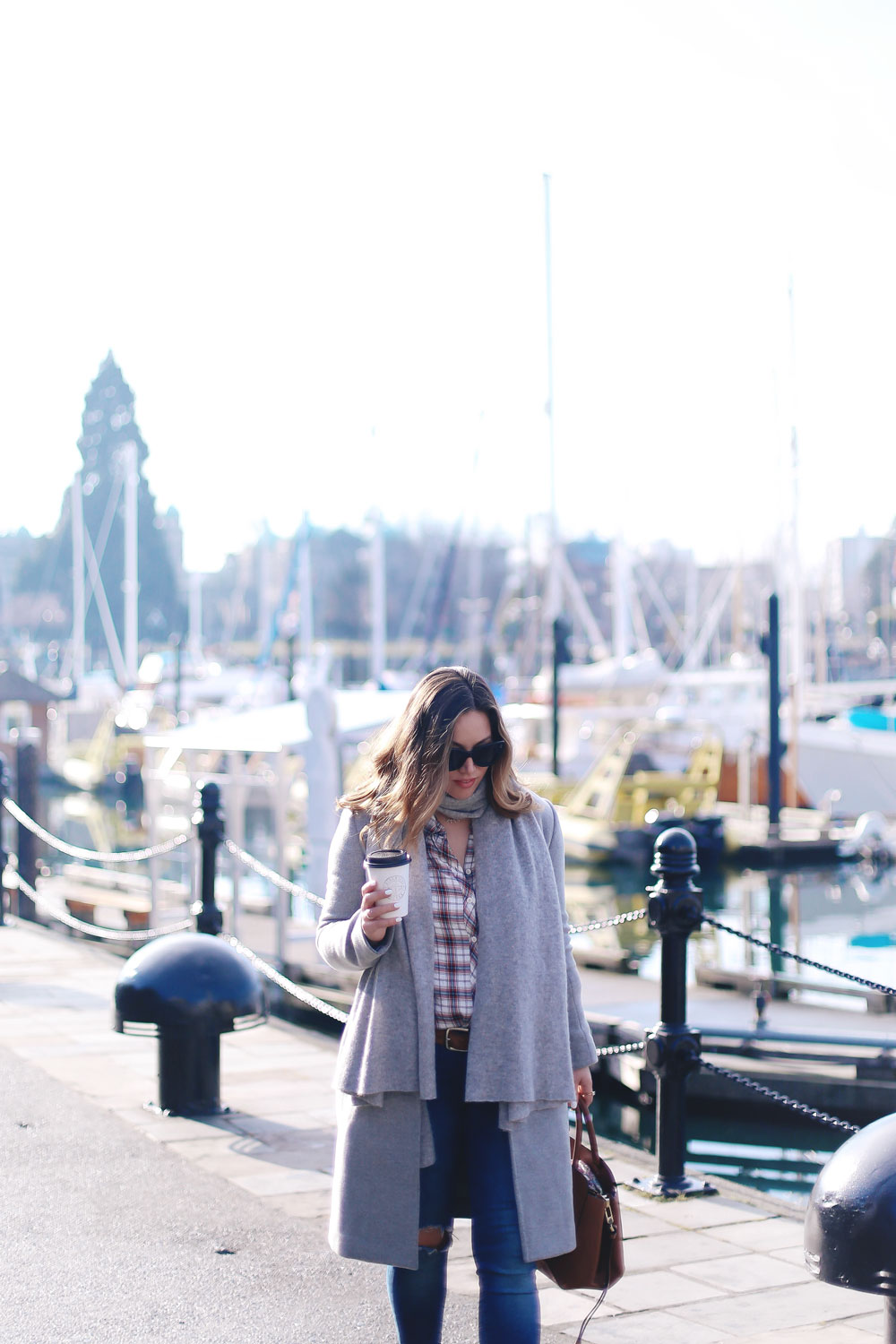 Plaid shirt styling tips in a grey wool coat, grey cashmere scarf, ripped skinny jeans, leather ankle boots and red plaid shirt