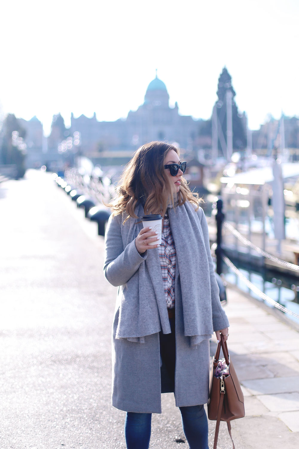 Plaid shirt styling tips in a grey wool coat, grey cashmere scarf, ripped skinny jeans, leather ankle boots and red plaid shirt