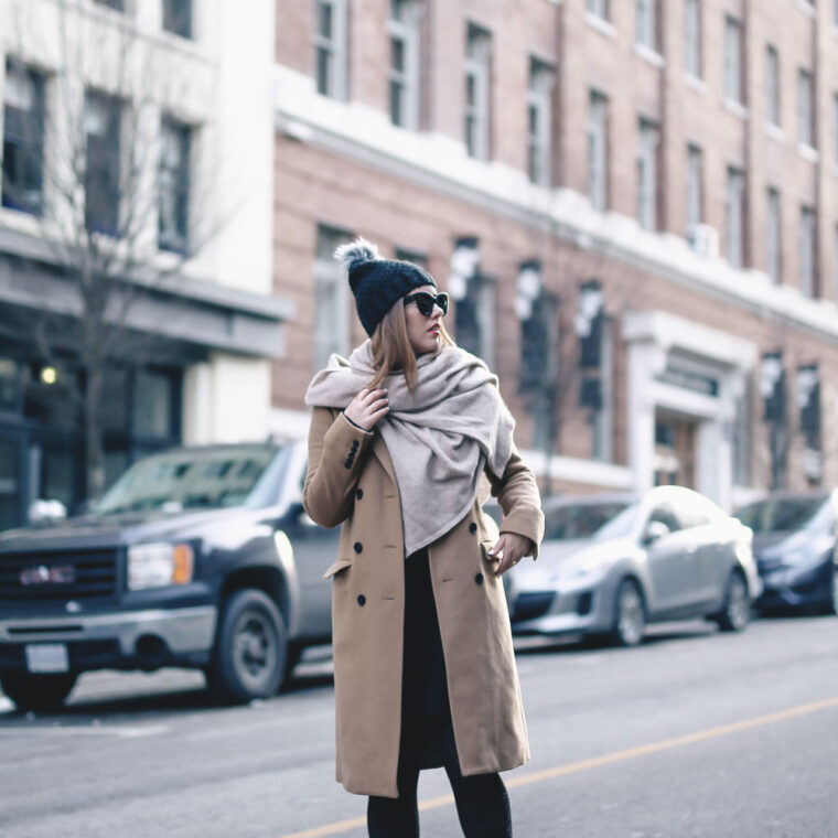 Tips on wearing a dress in the winter styled by To Vogue or Bust in an Aritzia camel wool coat, White and Warren cashmere dress, White and Warren cashmere travel wrap, Frye ankle boots, Express beanie hat and Celine Caty sunglasses