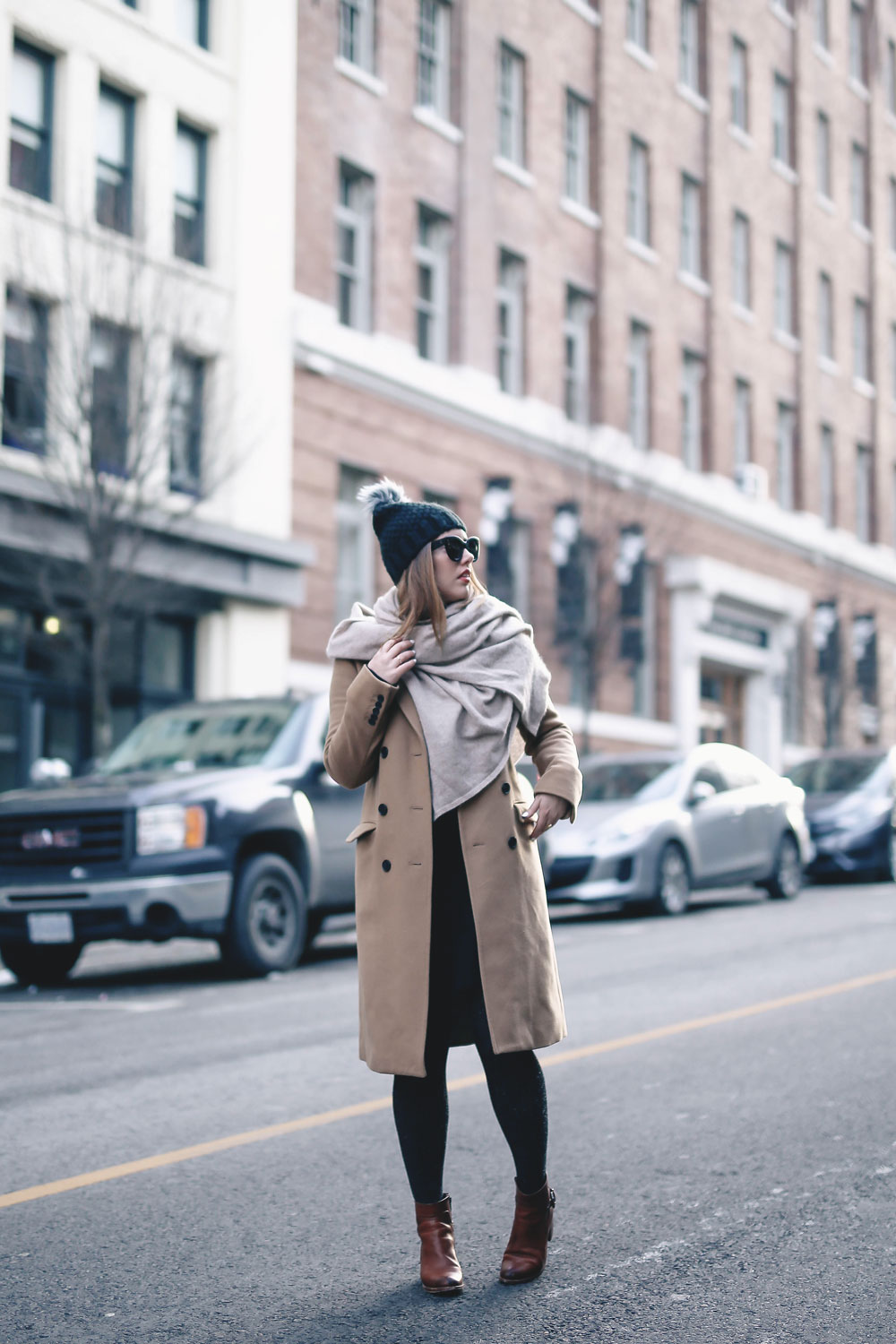 Tips on wearing a dress in the winter styled by To Vogue or Bust in an Aritzia camel wool coat, White and Warren cashmere dress, White and Warren cashmere travel wrap, Frye ankle boots, Express beanie hat and Celine Caty sunglasses
