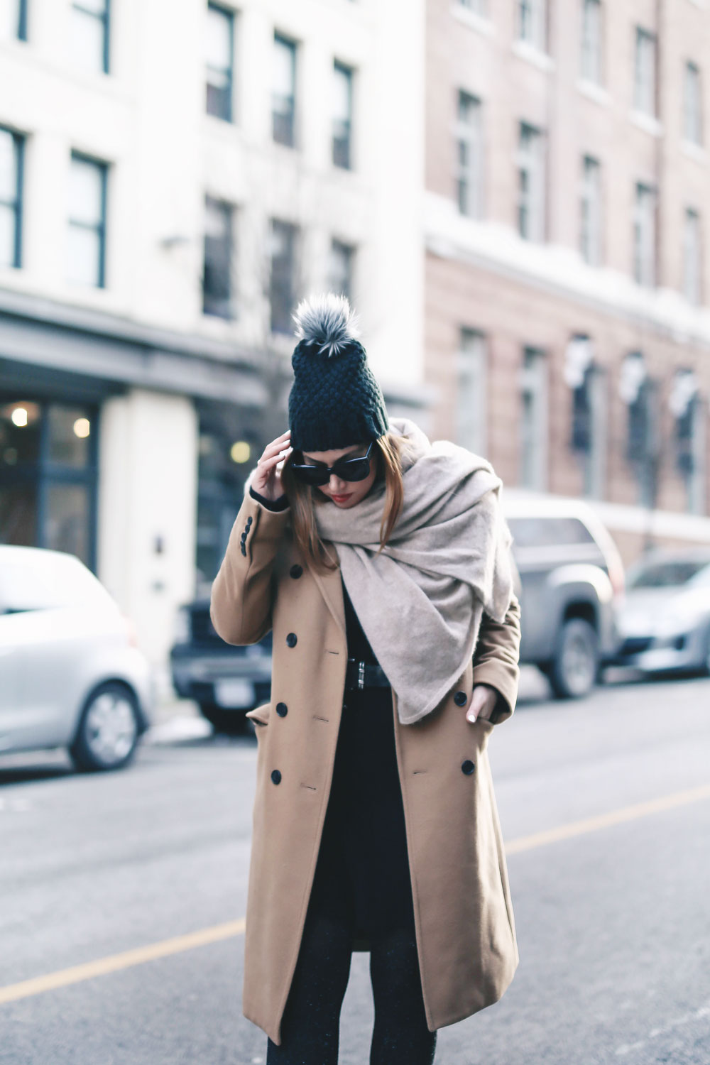 Tips on wearing a dress in the winter styled by To Vogue or Bust in an Aritzia camel wool coat, White and Warren cashmere dress, White and Warren cashmere travel wrap, Frye ankle boots, Express beanie hat and Celine Caty sunglasses