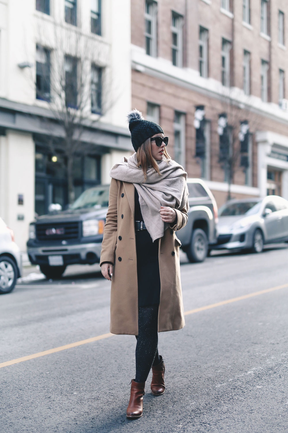 Tips on wearing a dress in the winter styled by To Vogue or Bust in an Aritzia camel wool coat, White and Warren cashmere dress, White and Warren cashmere travel wrap, Frye ankle boots, Express beanie hat and Celine Caty sunglasses