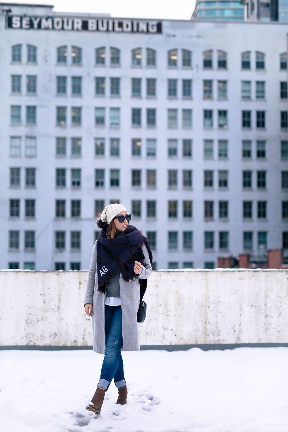 Cute outfit ideas in the snow - Aritzia blanket scarf, Aritzia grey wool coat, Tilley beanie, Mavi skinny jeans, Urban Outfitters ankle boots, Celine Caty sunglasses, layered oxford shirt