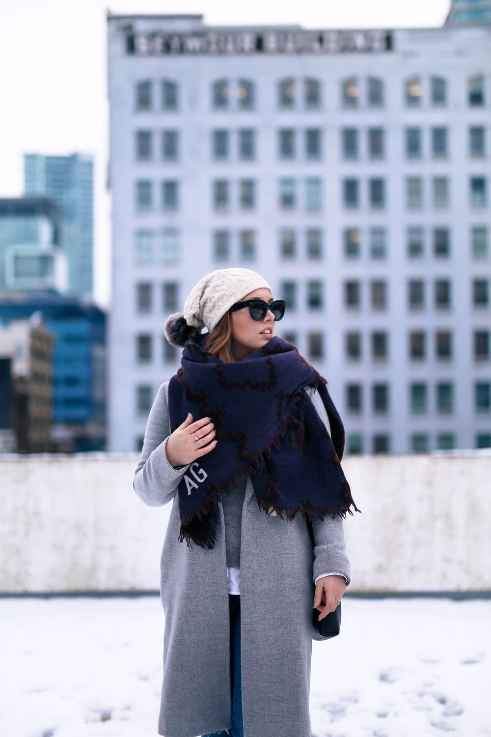 Cute outfit ideas in the snow - Aritzia blanket scarf, Aritzia grey wool coat, Tilley beanie, Mavi skinny jeans, Urban Outfitters ankle boots, Celine Caty sunglasses, layered oxford shirt
