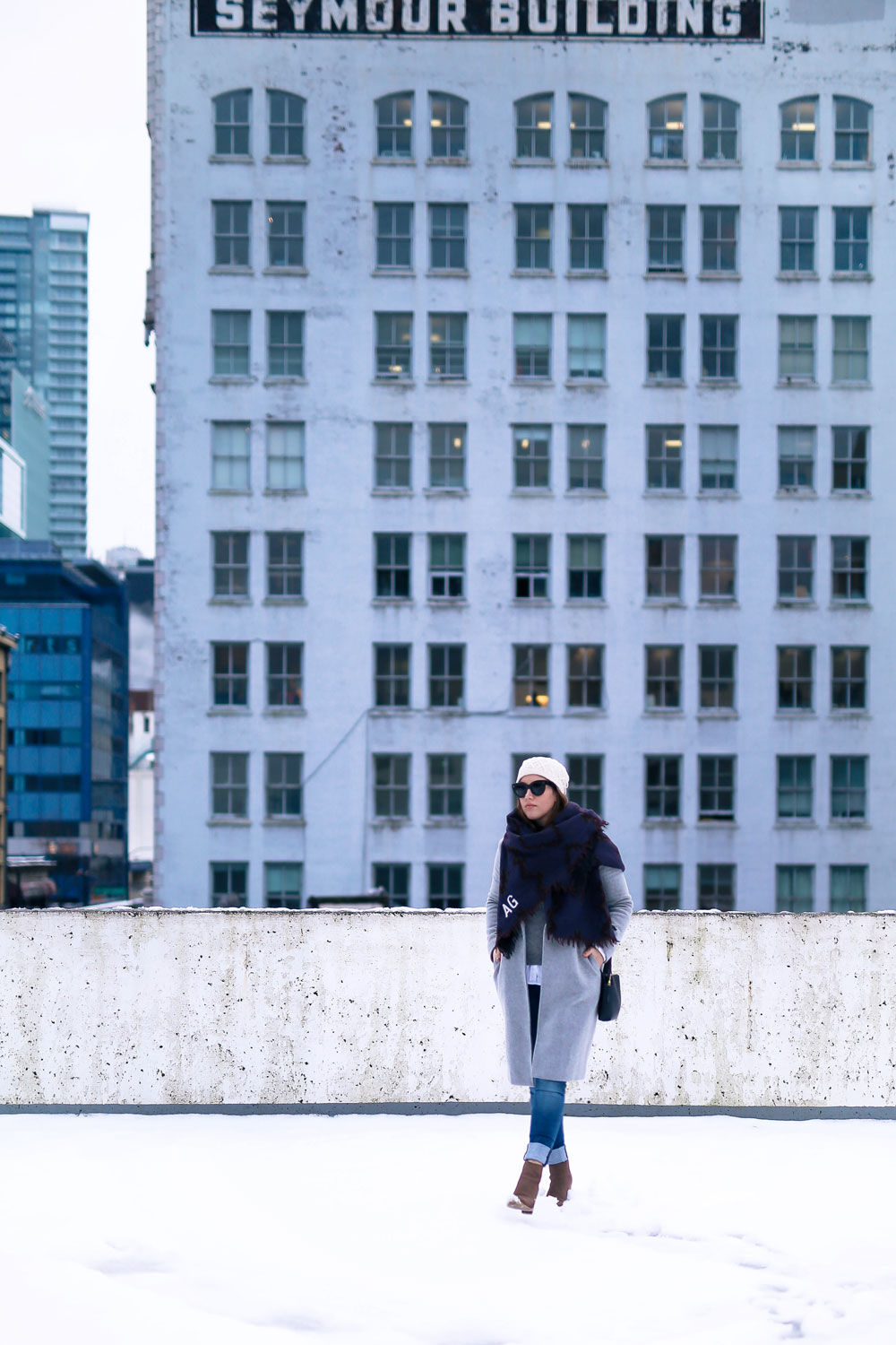 Cute outfit ideas in the snow - Aritzia blanket scarf, Aritzia grey wool coat, Tilley beanie, Mavi skinny jeans, Urban Outfitters ankle boots, Celine Caty sunglasses, layered oxford shirt