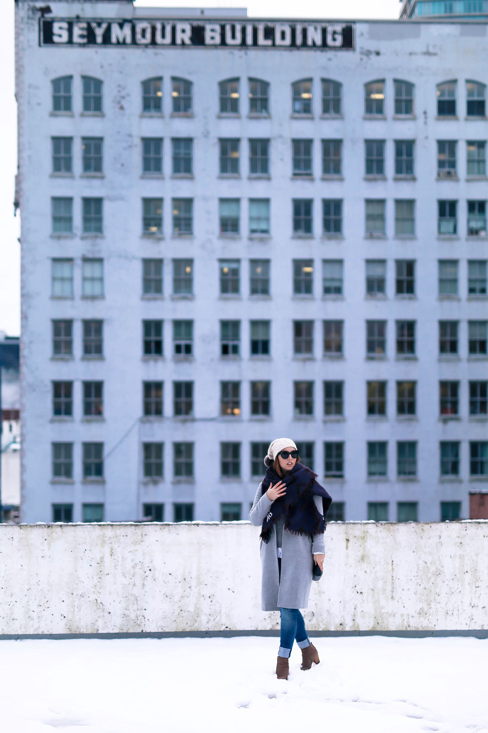 Cute outfit ideas in the snow - Aritzia blanket scarf, Aritzia grey wool coat, Tilley beanie, Mavi skinny jeans, Urban Outfitters ankle boots, Celine Caty sunglasses, layered oxford shirt