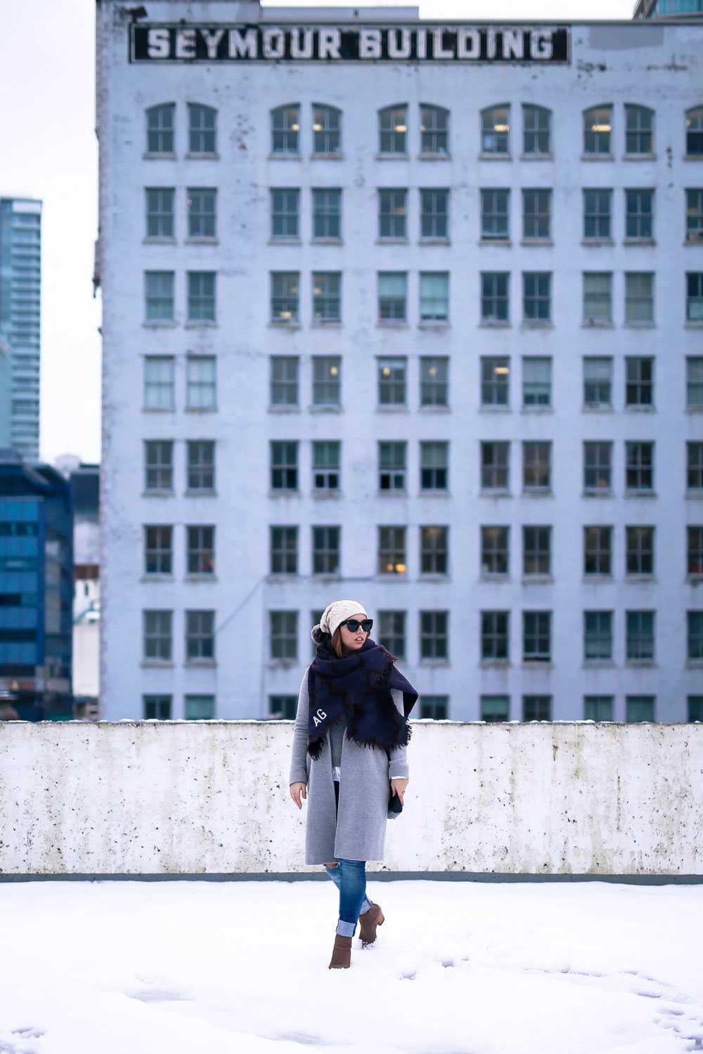 Cute outfit ideas in the snow - Aritzia blanket scarf, Aritzia grey wool coat, Tilley beanie, Mavi skinny jeans, Urban Outfitters ankle boots, Celine Caty sunglasses, layered oxford shirt