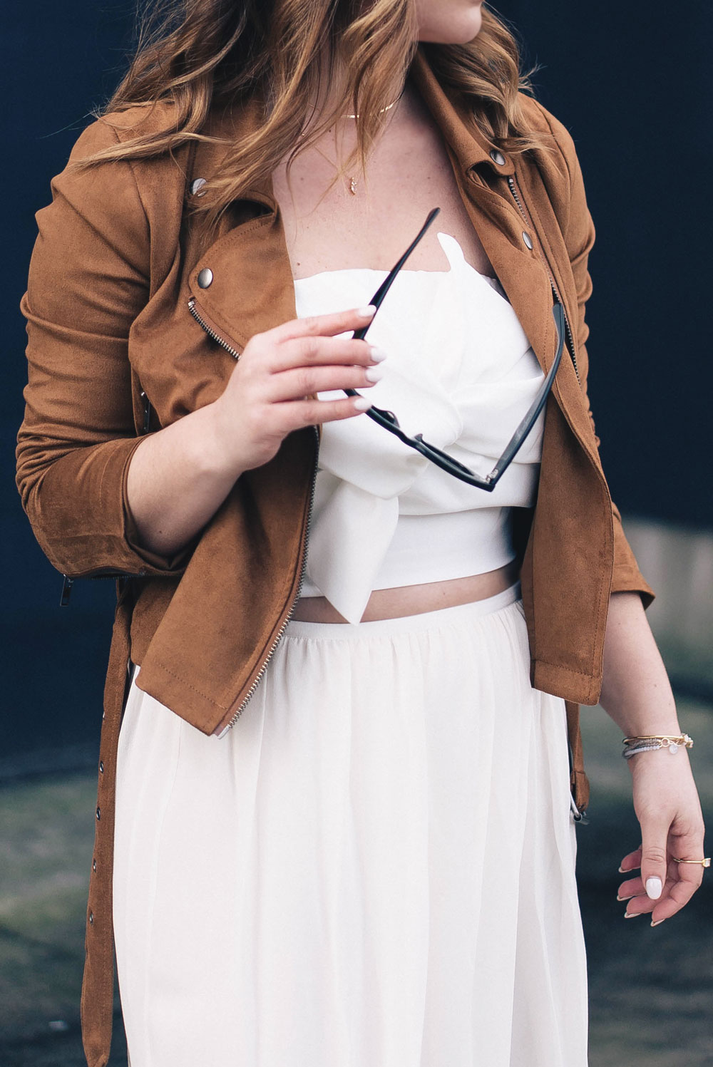 Western trend style tips in Lovers + Friends suede jacket, Revolve clothing, Aritzia skirt, Chicwish cropped top, Raye heels, Bega bag, Leah Alexandra jewelry, Celine sunglasses styled by To Vogue or Bust