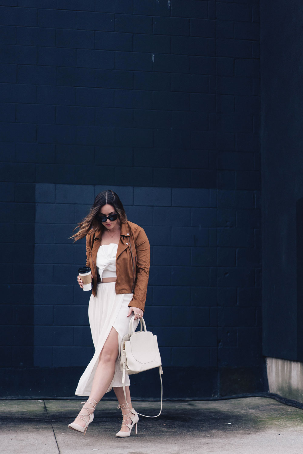 Western trend style tips in Lovers + Friends suede jacket, Revolve clothing, Aritzia skirt, Chicwish cropped top, Raye heels, Bega bag, Leah Alexandra jewelry, Celine sunglasses styled by To Vogue or Bust