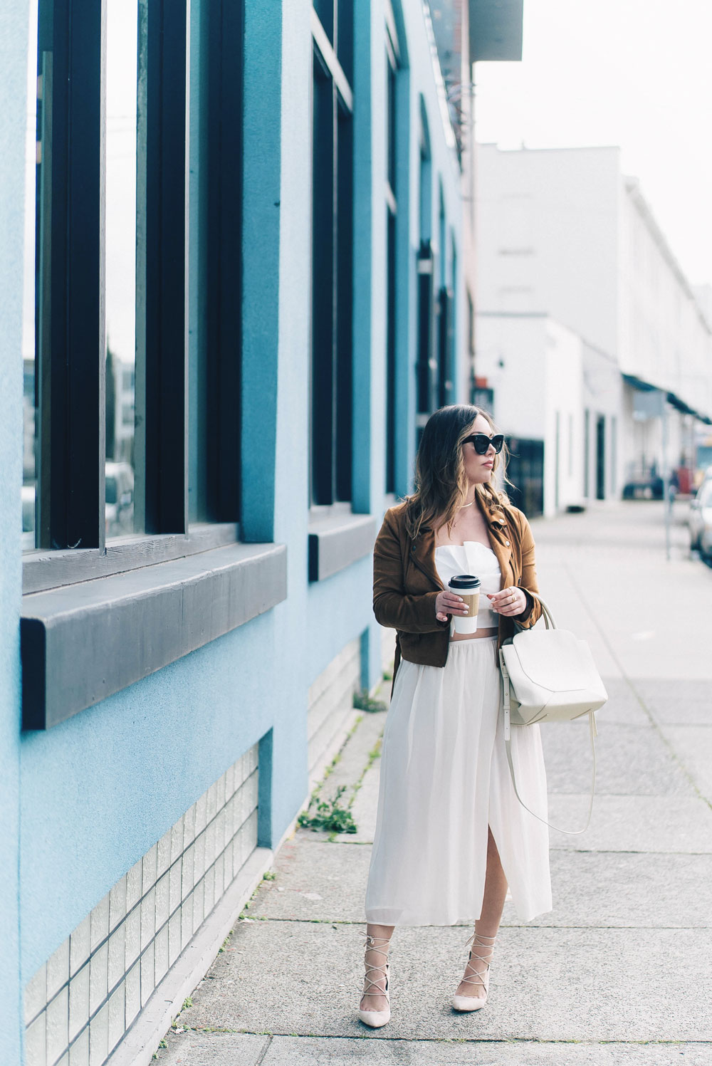 Western trend style tips in Lovers + Friends suede jacket, Revolve clothing, Aritzia skirt, Chicwish cropped top, Raye heels, Bega bag, Leah Alexandra jewelry, Celine sunglasses styled by To Vogue or Bust