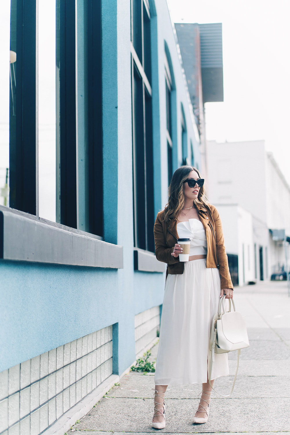 Western trend style tips in Lovers + Friends suede jacket, Revolve clothing, Aritzia skirt, Chicwish cropped top, Raye heels, Bega bag, Leah Alexandra jewelry, Celine sunglasses styled by To Vogue or Bust