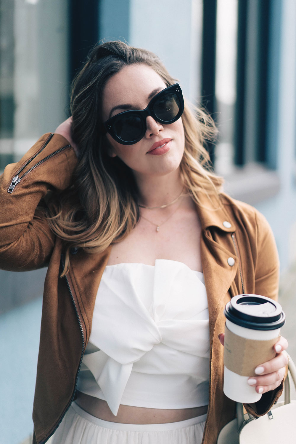 Western trend style tips in Lovers + Friends suede jacket, Revolve clothing, Aritzia skirt, Chicwish cropped top, Raye heels, Bega bag, Leah Alexandra jewelry, Celine sunglasses styled by To Vogue or Bust