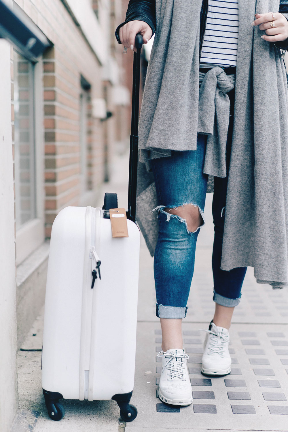 Outfits to wear while travelling on a plane in Ecco shoes, Leah Alexandra jewelry, best travel accessories, flight outfit ideas, airport style, what to wear on a plae, sneakers for flights, stylish luggage tags by To Vogue or Bust
