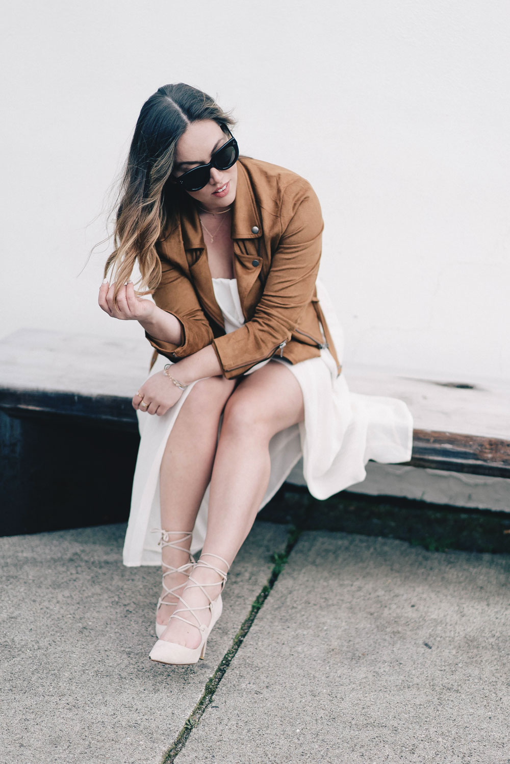 Western trend style tips in Lovers + Friends suede jacket, Revolve clothing, Aritzia skirt, Chicwish cropped top, Raye heels, Bega bag, Leah Alexandra jewelry, Celine sunglasses styled by To Vogue or Bust