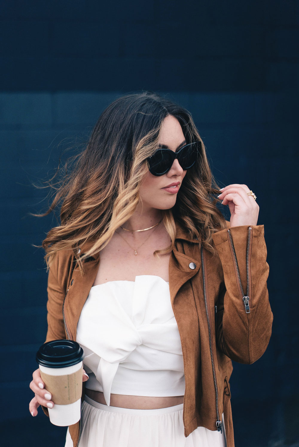 Western trend style tips in Lovers + Friends suede jacket, Revolve clothing, Aritzia skirt, Chicwish cropped top, Raye heels, Bega bag, Leah Alexandra jewelry, Celine sunglasses styled by To Vogue or Bust