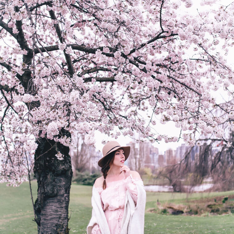 How to style off the shoulder spring trend in Revolve dress, Express wool fedora, Leah Alexandra jewellery, Revolve strapless dress, Mavi Coatigan, Lovers and Friends dress, how to wear strapless, cherry blossoms in Vancouver by To Vogue or Bust