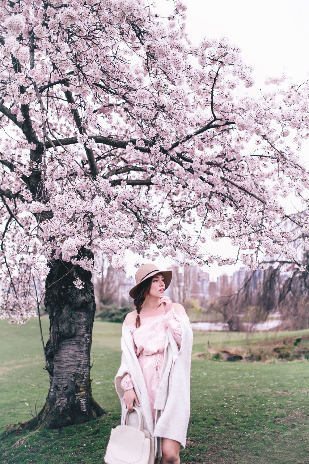 How to style off the shoulder spring trend in Revolve dress, Express wool fedora, Leah Alexandra jewellery, Revolve strapless dress, Mavi Coatigan, Lovers and Friends dress, how to wear strapless, cherry blossoms in Vancouver by To Vogue or Bust 