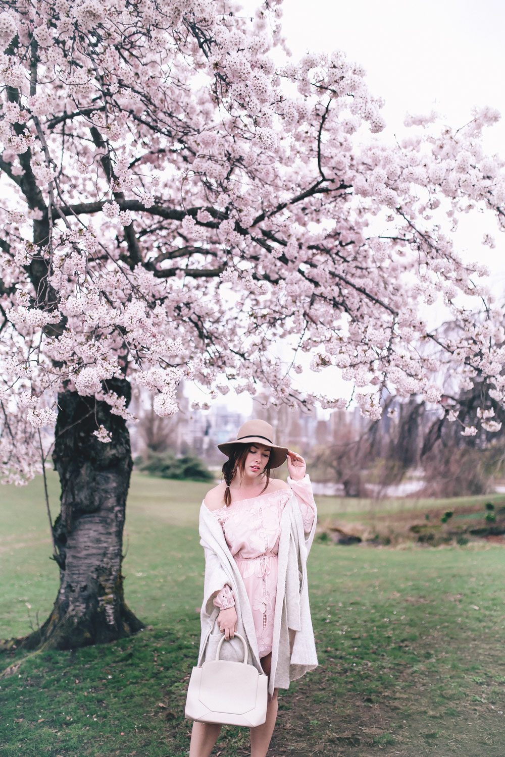 How to style off the shoulder spring trend in Revolve dress, Express wool fedora, Leah Alexandra jewellery, Revolve strapless dress, Mavi Coatigan, Lovers and Friends dress, how to wear strapless, cherry blossoms in Vancouver by To Vogue or Bust 