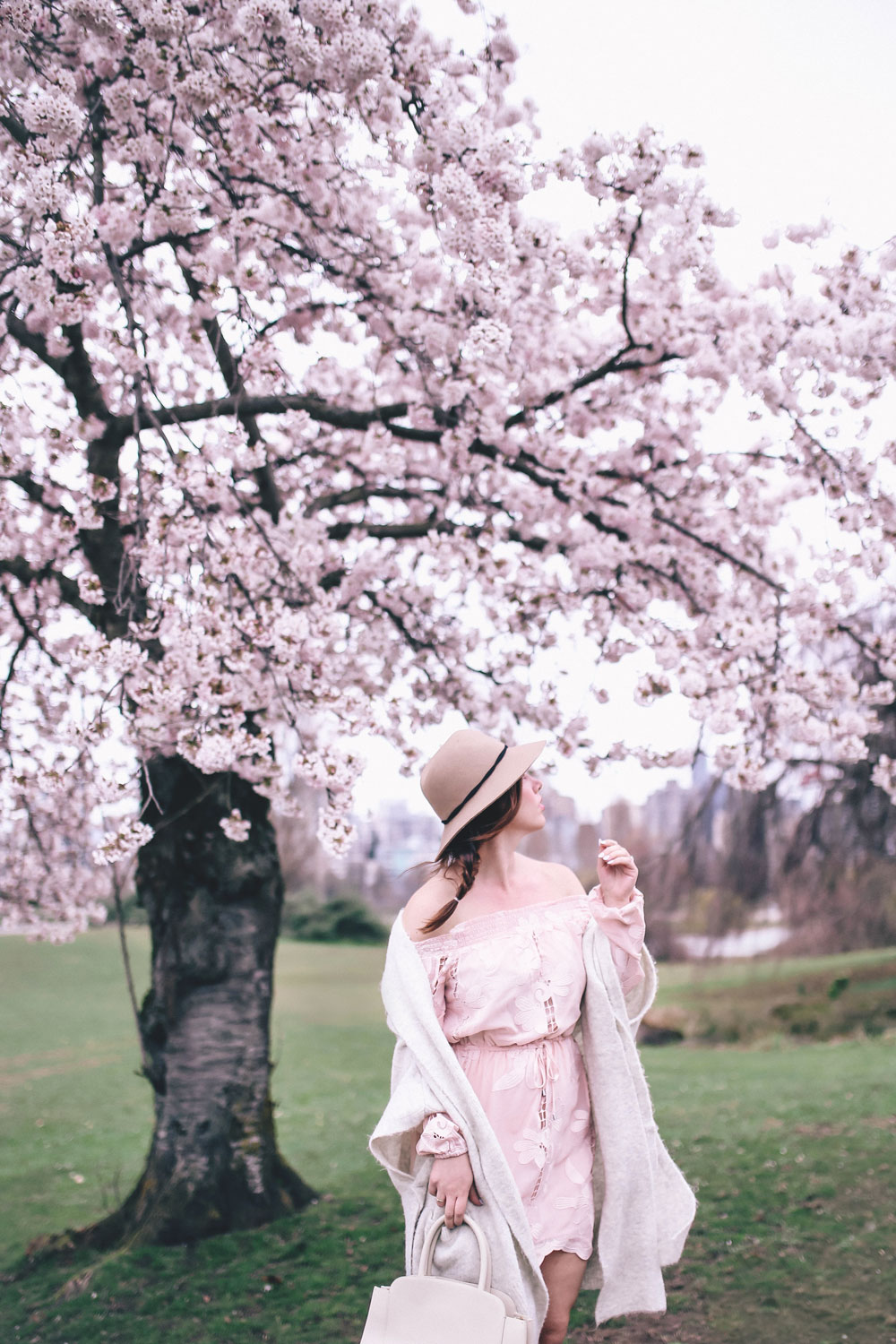 How to style off the shoulder spring trend in Revolve dress, Express wool fedora, Leah Alexandra jewellery, Revolve strapless dress, Mavi Coatigan, Lovers and Friends dress, how to wear strapless, cherry blossoms in Vancouver by To Vogue or Bust 