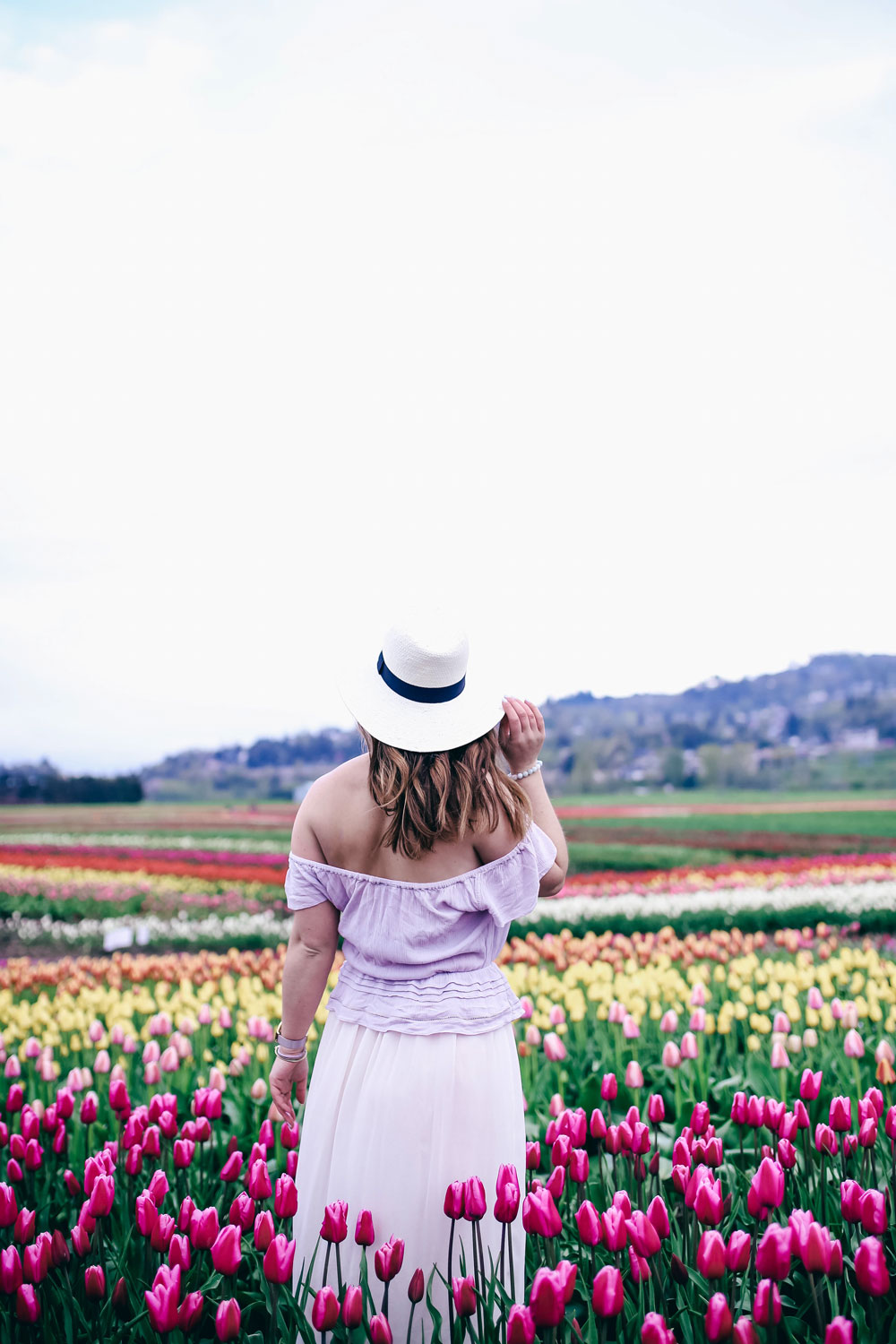 Tulip fields in Vancouver by To Vogue or Bust in an Aritzia silk skirt Aritzia off the shoulder top Joe Fresh panama hat